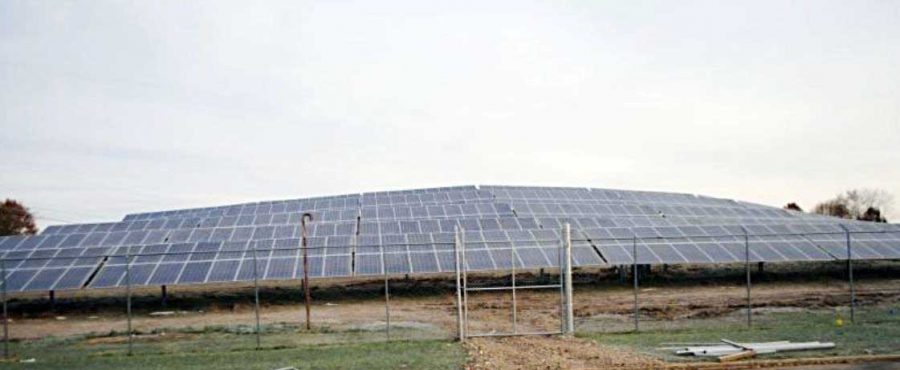 Solar panel field guarded by chain fence